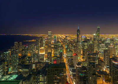 Aerial view of city lit up at night