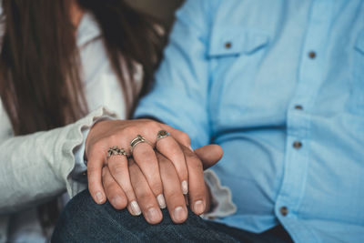 Midsection of couple holding hands