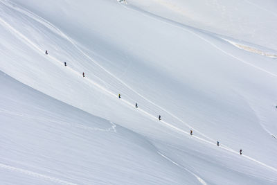 Hikers walking on snowcapped mountain