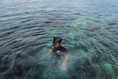 High angle view of man swimming in sea