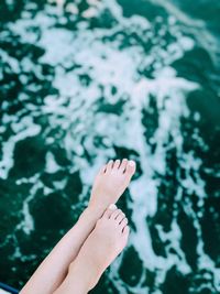 Low section of woman legs at sea