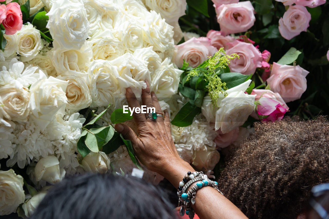 Midsection of woman with bouquet