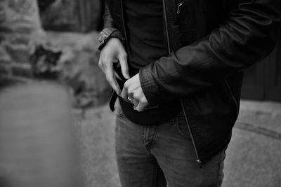 Mid section of one person with casual clothing